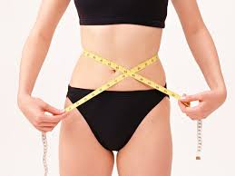 girl measuring her waist